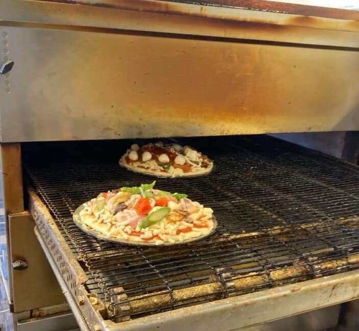 オーブンに吸い込まれるピザ